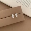 Elegant silver double-layered floral stud earrings with textured matte finish on display - Silver Double Five Petal Flower