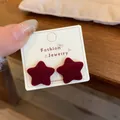 Minimalist burgundy flocked star stud earring displayed on fashion jewelry card - Red Star (ZRW20)