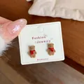 Cute brown flocked bear stud earrings with red scarf detail on jewelry card - Brown Bear (Red Scarf)