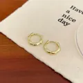 Chic golden bamboo style hoop earrings with zircon accents on a textured surface - Gold Bamboo Ear Buckle