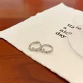 Silver bow hoop earrings with pink zircon stone inlay on white card background - Pink Zirconia Bowknot Ear Buckle