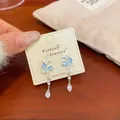 Elegant silver butterfly tassel earrings with sky blue resin wings and pear-cut crystal - Butterfly Cat Eye Pendant Style (HDW002) / Blue
