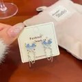 Silver butterfly earrings with light blue cat eye stones and long metal tassels - Blue Cat Eye Stone Tassel Style (FC2) / Blue