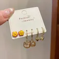 Three-pair gold earring set with yellow flowers, brown cat and heart pendants - Floral Red Knot Style