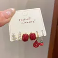 Mix ear cuff set featuring red gemstones, pearls, and Chinese Fu character motifs - New Year Persimmon Style