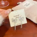 Silver bow earrings with lavender cat's eye stones and long sparkling tassels - Pink Cat Eye Butterfly Tassel Style (NV7)