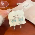 Silver-tone butterfly tassel earrings with blue gradient wings and sparkling rhinestones - Blue Cat Eye Butterfly Tassel Style (NV8)