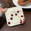 Elegant red flocked heart and butterfly earring set for women on beige card display - Seven Pair Pack / Red Square Flower Style
