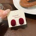 Dark red velvet oval stud earrings displayed on a white jewelry card for women - HSR06 Red Flocked Round