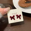 Elegant wine red velvet bow stud earrings for women presented on a jewelry card - HSR04 Red Flocked Bowknot