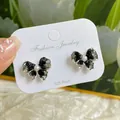 Elegant silver post bow earrings with black gradient crystals and small white pearl detail - Full Crystal Black Bowknot