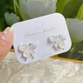 Elegant 925 silver stud earrings featuring white butterfly wings and pearl flower details - Blue Butterfly and Flower