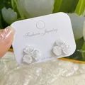 Elegant white flower stud earrings with shimmering texture and sparkling zircon center - Crystal Three-Petal Flower