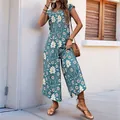 Bohemian floral wide leg jumpsuit in teal with short sleeves and leaf print design - Blue