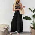 Elegant black halter wide-leg jumpsuit with colorful floral embroidery and mesh details - S / Black