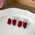 Elegant burgundy velvet bow earrings with white pearls and gold metal accents - Red Bowknot With Pearls