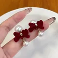 Elegant red velvet bow earrings with white pearls and gold accents for a vintage look - Bowknot With Pearl Dangle