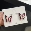 Flocked butterfly earrings in deep burgundy and cream white on a white display card - Red And White Double Layer Butterfly (RV16)