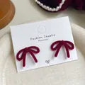 Elegant Ankara red flocked bow earrings on display card with soft velvet background - Ancorra Red Bowknot (RV20)