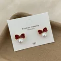 Dark red enamel bow earrings with white pearl detail on white display card - Fan Leaf Bow Artificial Pearl Style