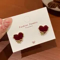 Elegant red velvet heart stud earrings with golden bow accents on a jewelry card - Gold Heart Edge (RV29)