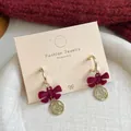 Elegant red velvet bow earrings with gold-toned lucky charm and circular hoop detail - Fu Character Bowknot (RV10)