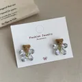 Brown flocked bear earrings with crystal petals on a cozy textile background - Crystal Bear (VF28) / Brown