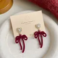 Elegant deep red flocked bow earrings with heart studs and faux pearls on white tray - Layered Long Bowknot (RV12)