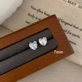 Delicate 7mm heart-shaped cubic zirconia stud earrings in a silver claw setting - Four-Claw Heart Style / 7mm / Clear White