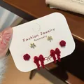 Three-pair red velvet bow and golden flower stud earring set on white card - Red Bow
