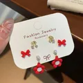 Three-pair earring set featuring red bows, golden cherries, and pearl flower drops - Little Red Flower