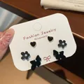Three pairs of elegant black velvet bow and heart earrings with pearl accents - Black Flower