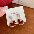 Red flocked rocking horse earrings with pearls and rhinestones on a white card - Red Velvet Horse Drop Earrings (SRM)