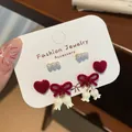 Three pairs of festive red flocked bow and heart earrings set with silver needles - White Lily of the Valley