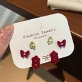 Three pairs of red flocked butterfly and flower stud earrings set with pearls - Double Flower