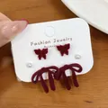 Dark red velvet flocked bow and hollow butterfly stud earring set on white card - Woven Knot (VQ6)