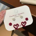 Three-pair earring set featuring red flocked bows and white heart pearl studs - Hollow Heart