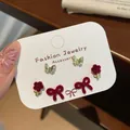 Three-pair earring set with red flocked bows and crystal flowers on white card - Rose
