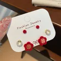 Three-piece festive red flocked bow and floral earring set with pearl and gold accents - Red Flower