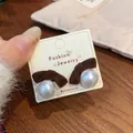 Elegant deep red flocked bow earrings with large white pearl details on display - Brown Bowknot Pearl (ZZW4)