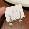 Pink tulip earrings with white pearls and gold hooks on fashion jewelry display card - Pearl Ring Tulip (SDE4)