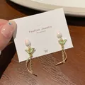 Pink tulip earrings with green leaves and gold tassel on a white display card - Dancing Cherry Blossom (FA1)