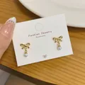 Minimalist gold bow earrings with pearls on a card display from the daily set - Gold Butterfly Bow Pearl Pendant (SS135)