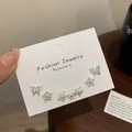Three pairs of silver stud earrings featuring butterfly, snowflake, and pearl flower designs - Silver Flower Set (YTZT001)