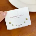 Three pairs of gold star and moon stud earrings set on a white card, elegant jewelry - Gold Star Moon Earring Set (JTZT005)