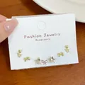 Three-pair gold stud earring set featuring butterfly, tulip, and star shapes on a card - Gold Cat Earring Set (JTZT006)