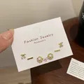 Three-pair gold earring set featuring cherry charms, bars and faux pearls on display card - Gold Round Hoop Pearl Set (JTZT008)