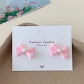 Pink fabric bow earrings with silver heart detail on display card for women - Red Heart Bowtie