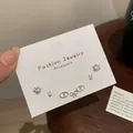 Set of four silver minimalist stud earrings featuring cat paws, rabbit, and oval link motifs - Silver Cat Paw Earring Set (YTZT003)