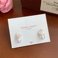 Pink heart-shaped earrings with white pearl drops on elegant jewelry card - Pearl Pink Heart (YRH1)